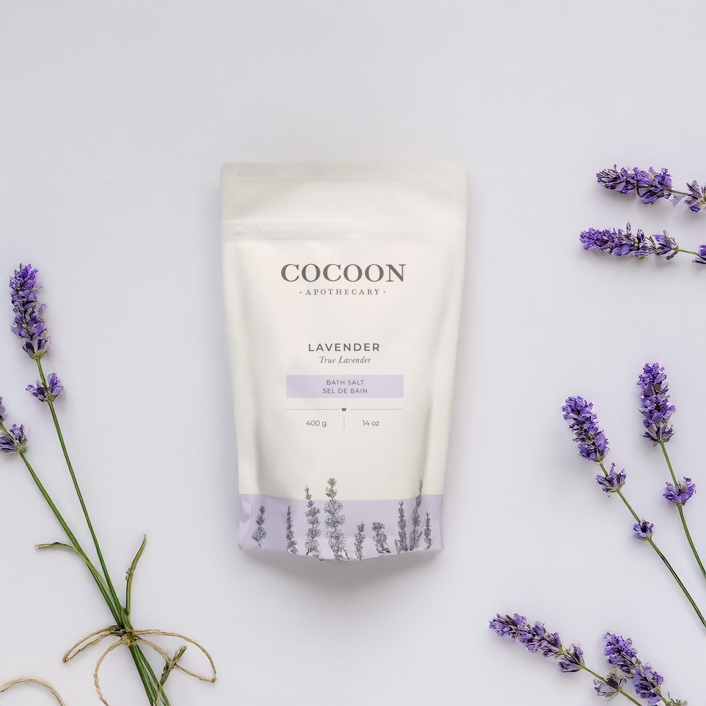 Cocoon Apothecary lavender bath salt packaging with lavender flowers on a light background
