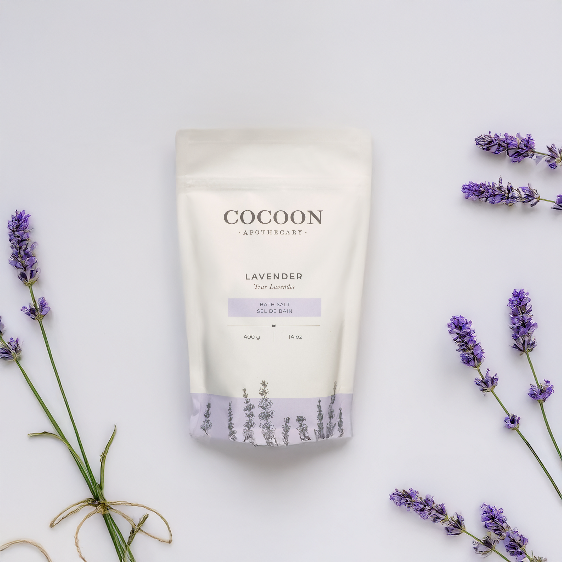 Cocoon Apothecary lavender bath salt packaging with lavender flowers on a light background