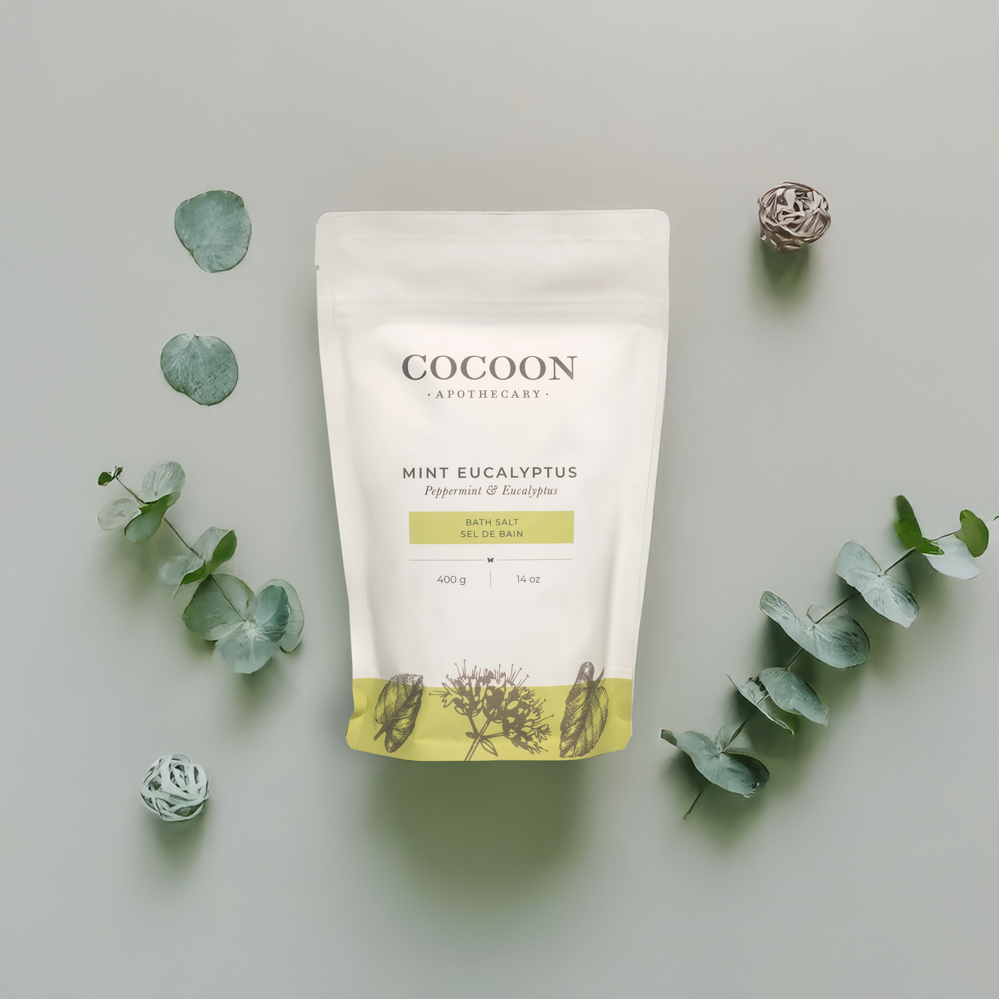 Cocoon bath salt package with eucalyptus leaves on a light gray background
