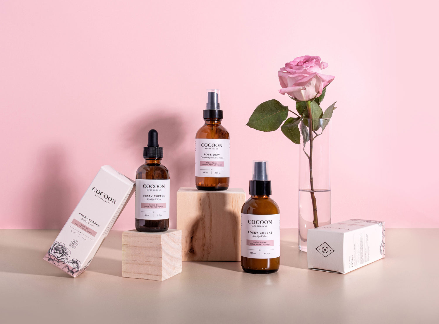 Luxury plant-based skincare with rose petals and amber glass packaging