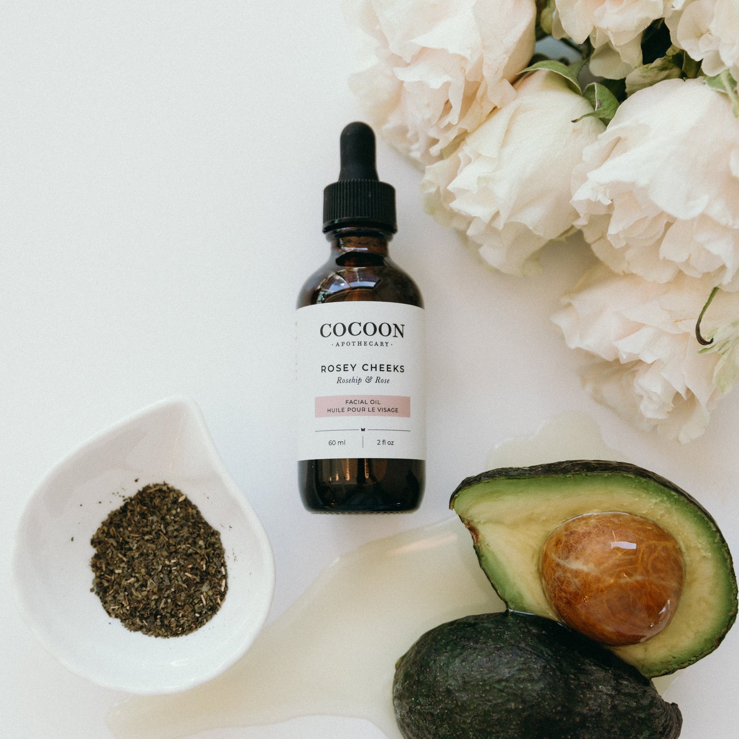 Cocoon Rosey Cheese skincare product with avocado, rose, and green tea on a white background