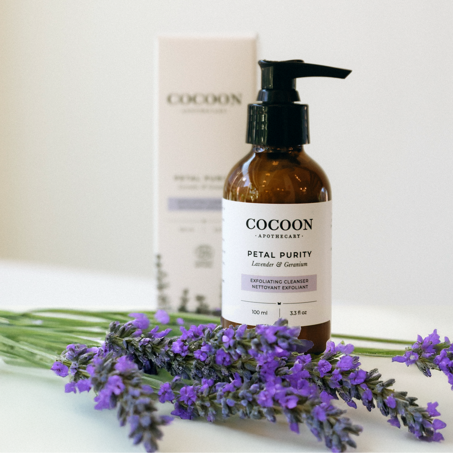 Cocoon skincare product with lavender flowers on a white background