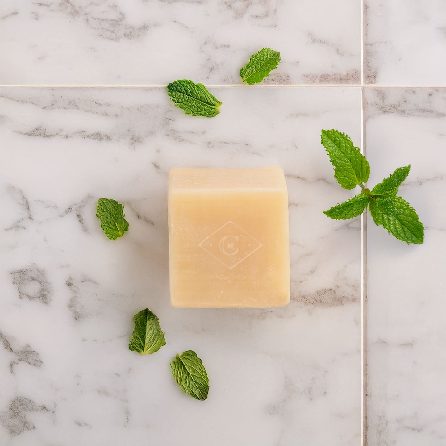peppermint bar soap on bathroom floor with mint sprigs