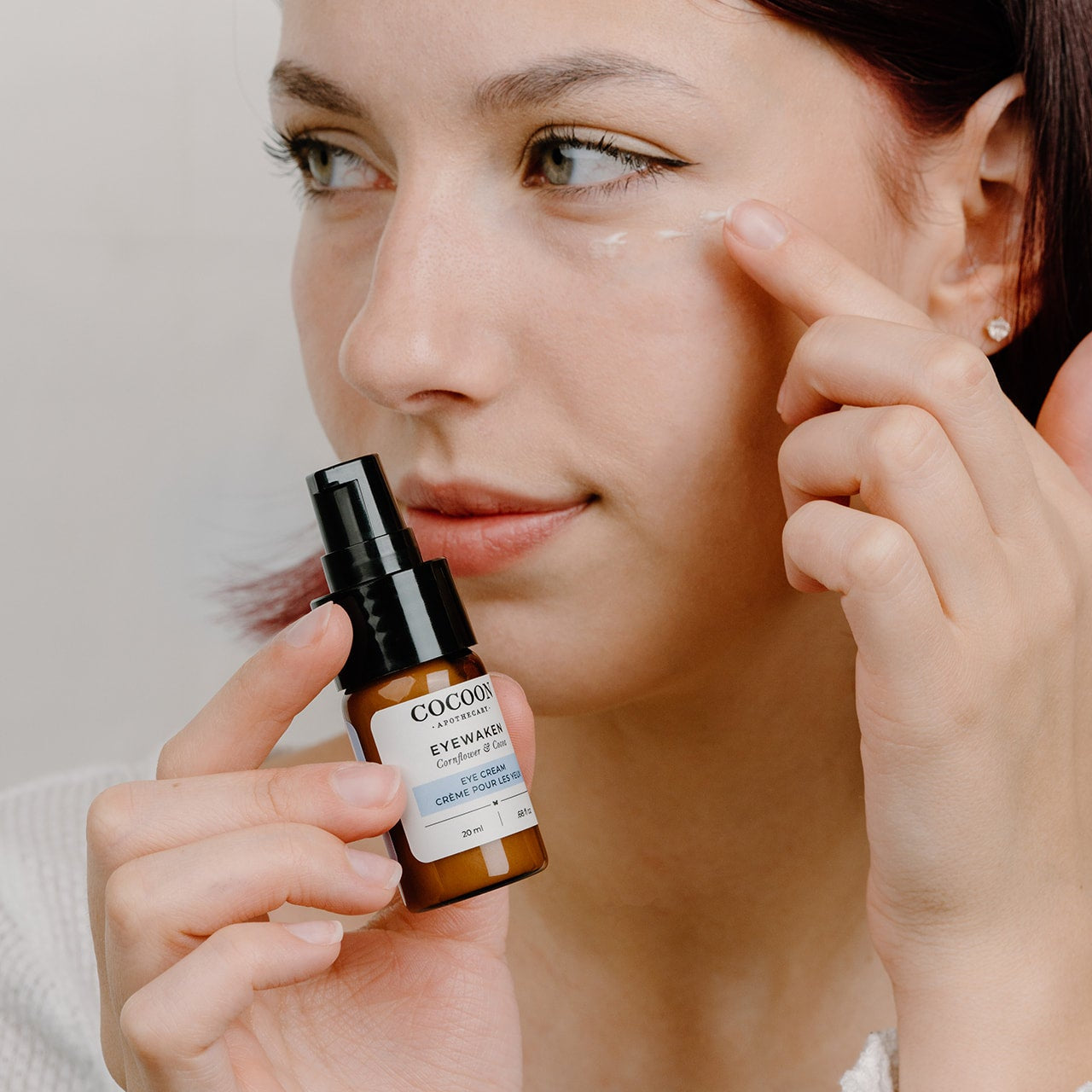 hand applying cream under eye