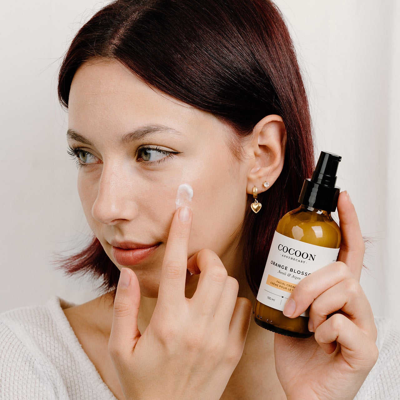 Applying Orange Blossom Facial Cream to face — lightweight matte finish