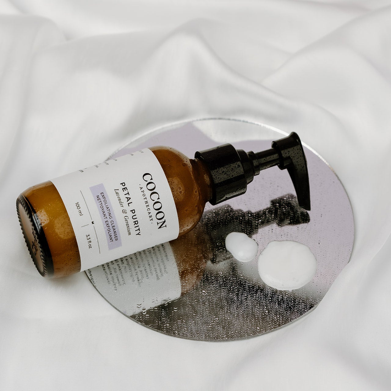 creamy texture of milk cleanser with jojoba beads