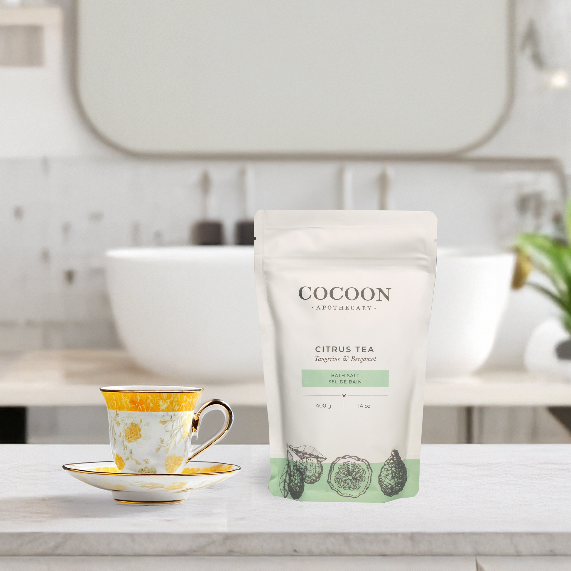 Cocoon Apothecary Citrus Tea package on a bathroom counter with a cup and saucer.