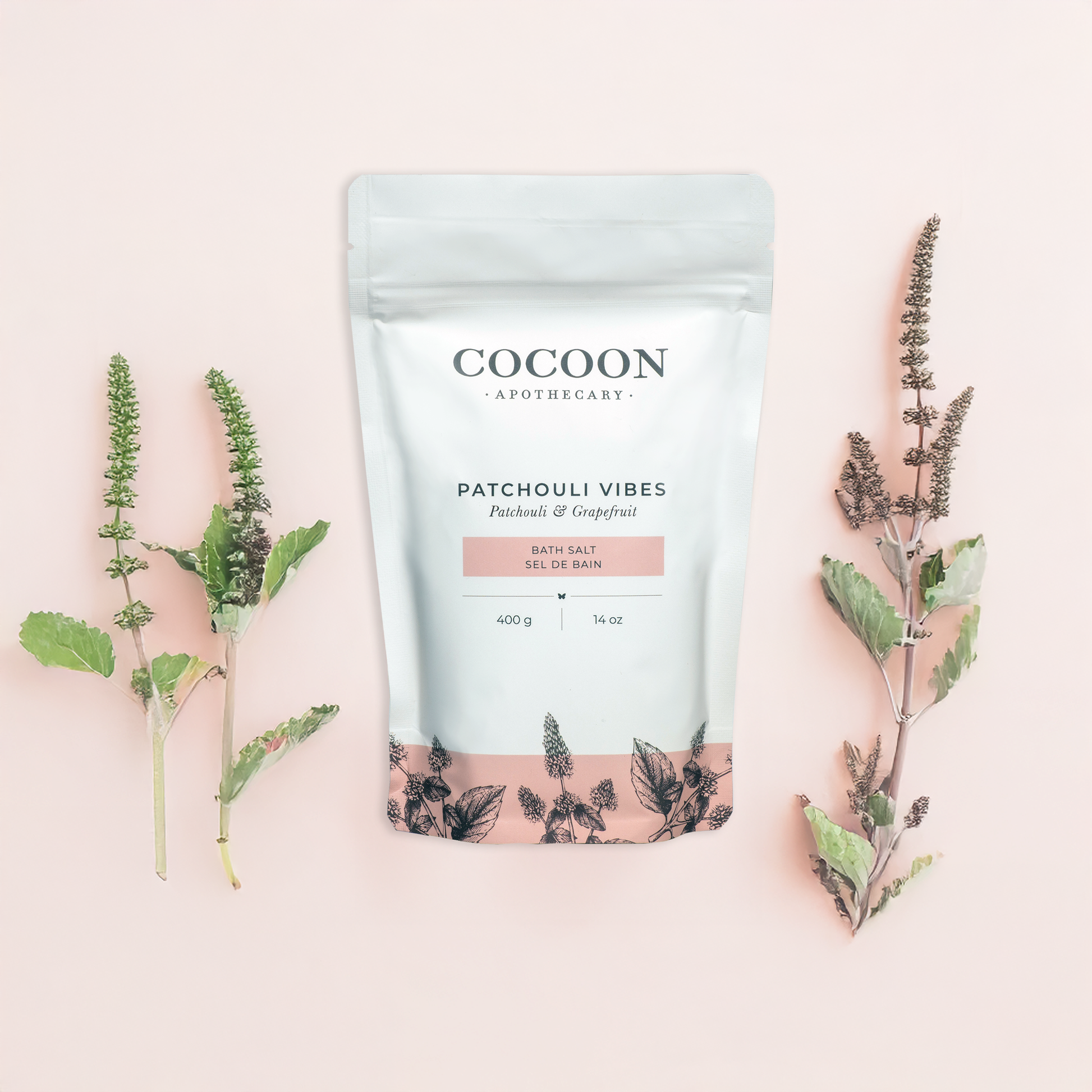Cocoon Apothecary Patchouli Vibes product packaging with herbs on a pink background