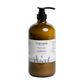 Amber glass bottle with pump and 'Cocoon Apothecary' label on a white background