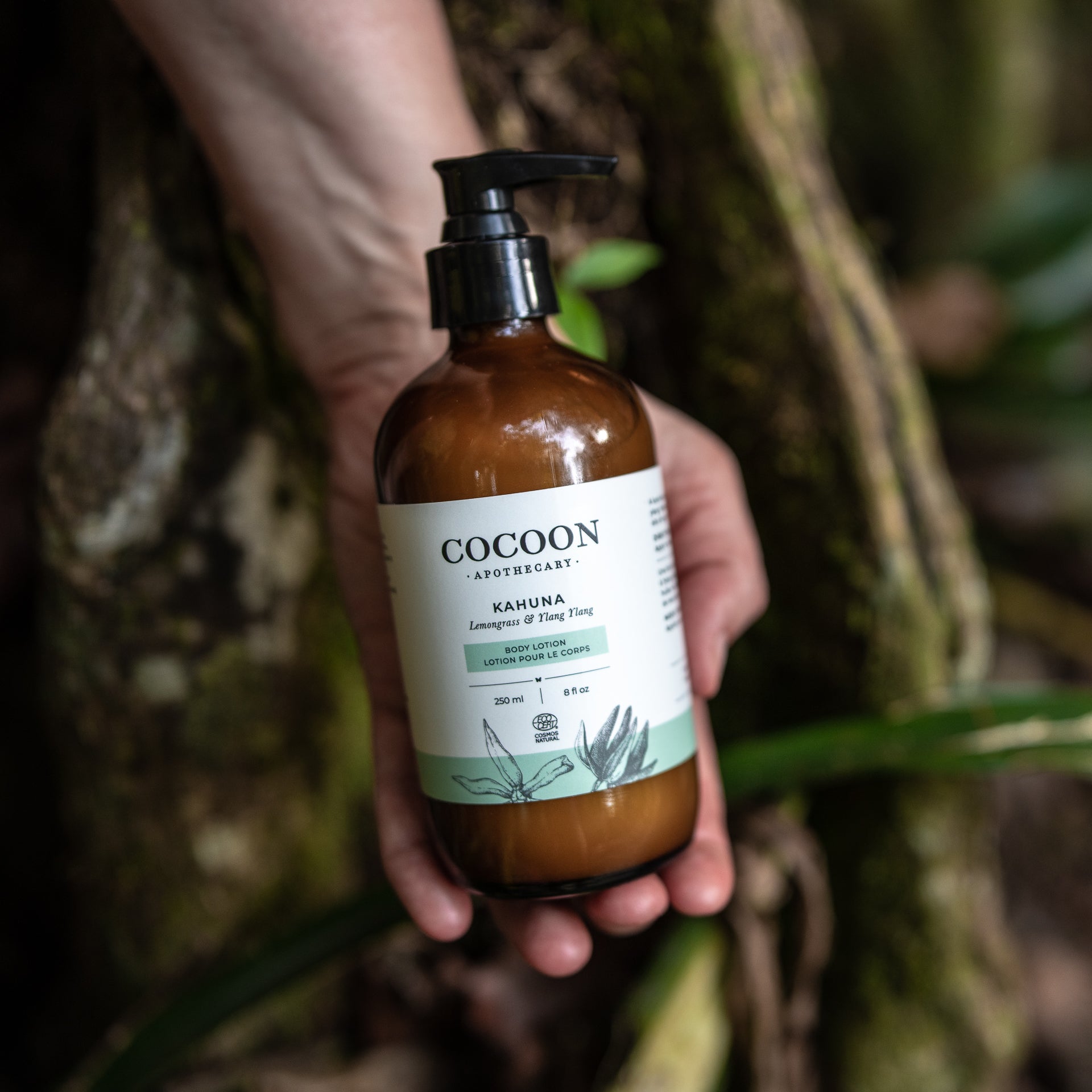 Kahuna Body Lotion glass bottle in a tropical setting – eco-friendly skincare part of Cocoon Apothecary Bottle Return Program.