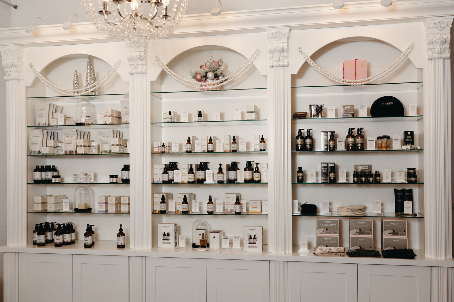 Shelving unit with various skincare products in a well-lit room