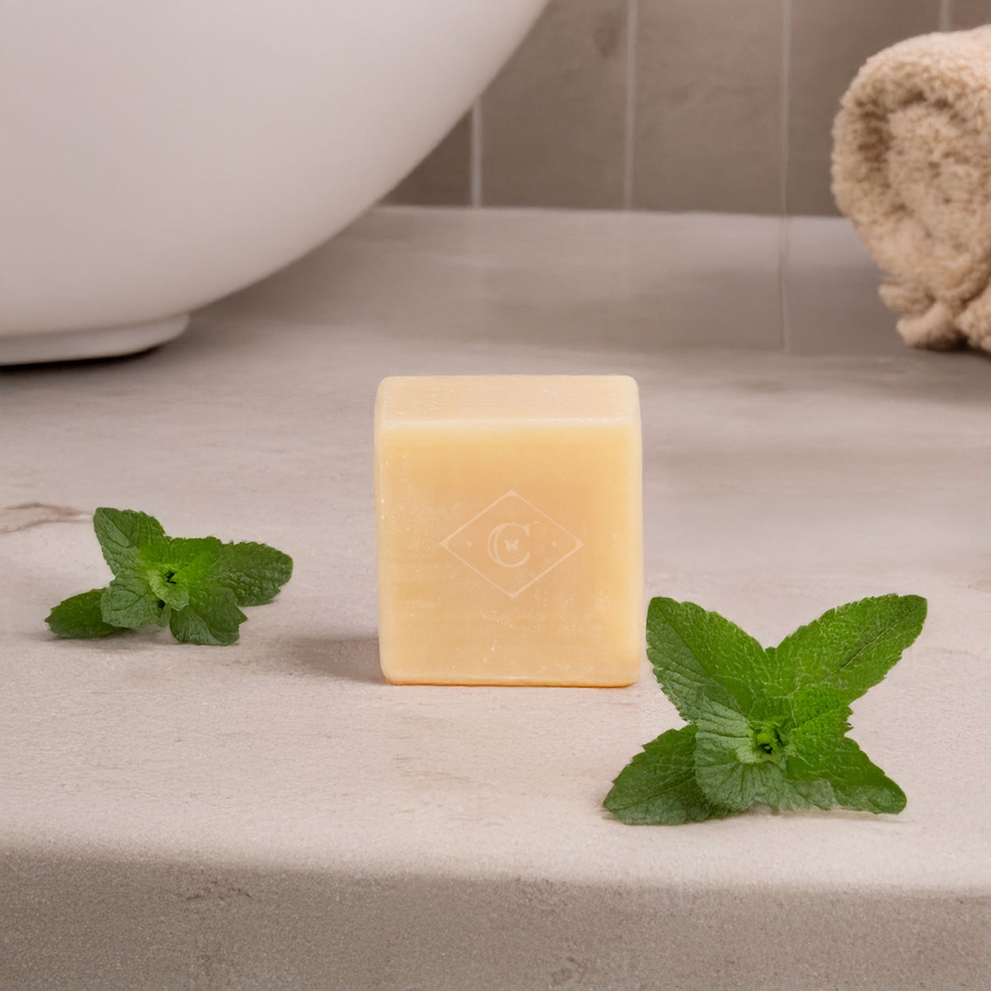 Bar of soap with mint leaves on a bathroom counter
