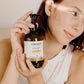 Person holding a bottle of Cocoon Sweet Orange product showing the gentle aloe based gel cleanser