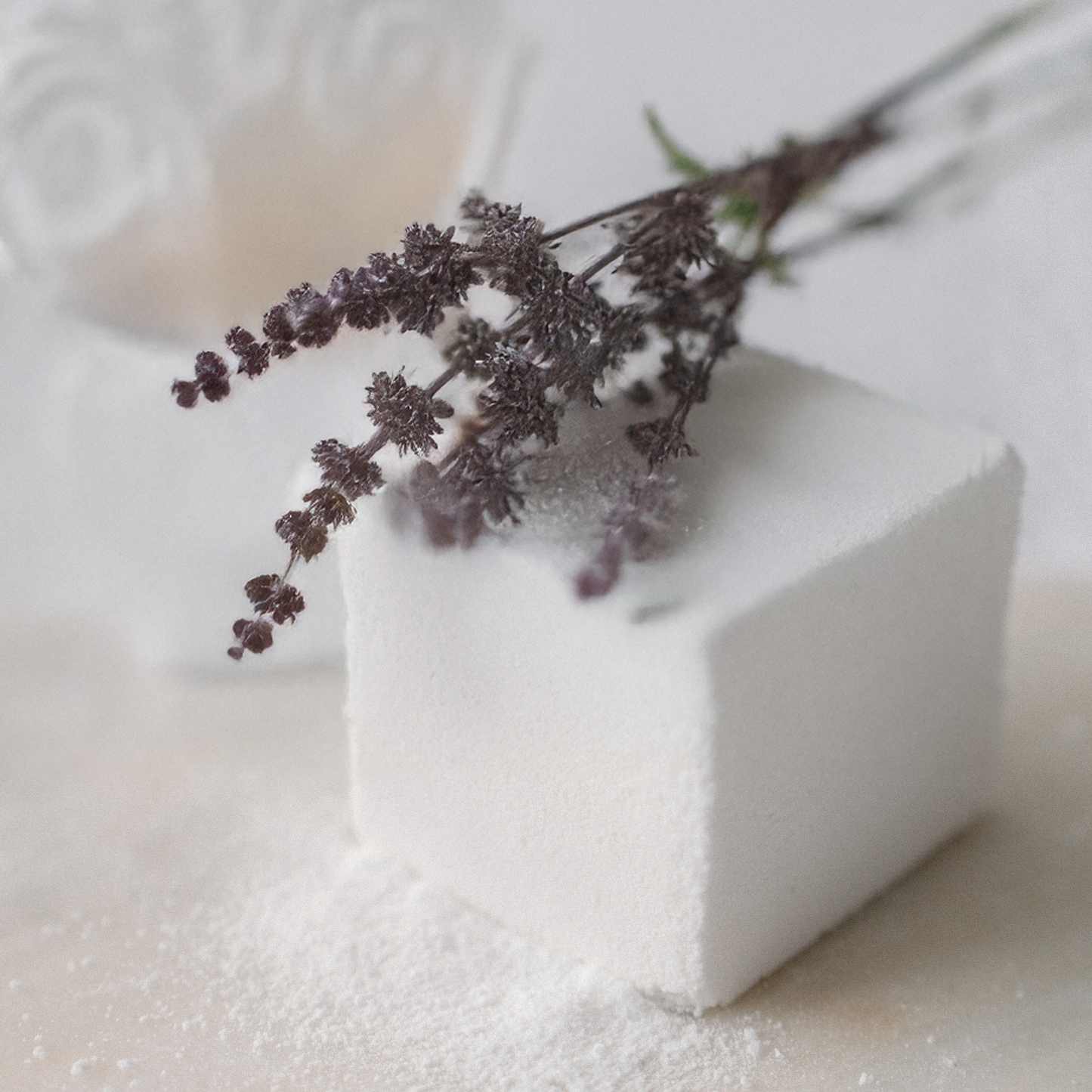 bath cube with a branch of dried patchouli on a white background