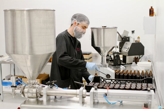 Cocoon employee working in a laboratory setting with equipment and bottles.