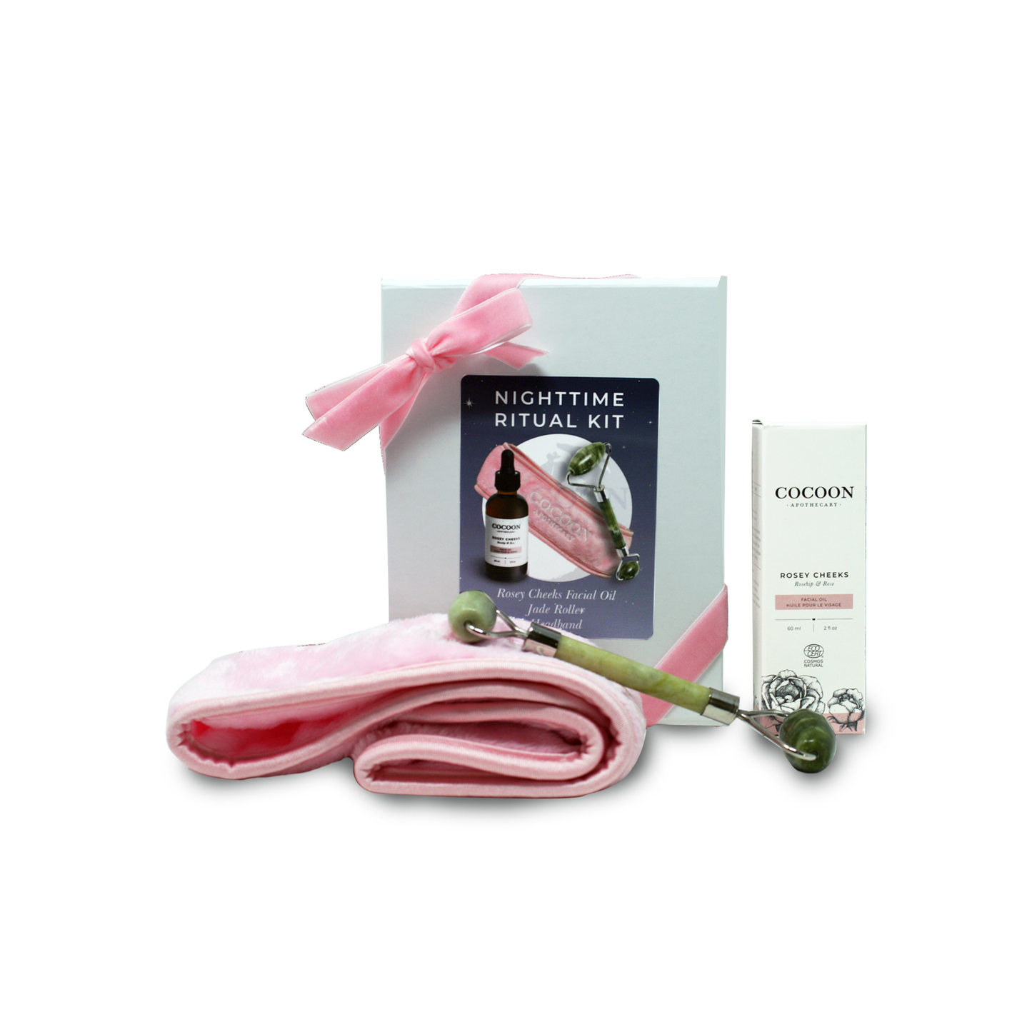 Nighttime ritual kit with jade roller, Rosey Cheeks Facial Oil, and a pink headband.