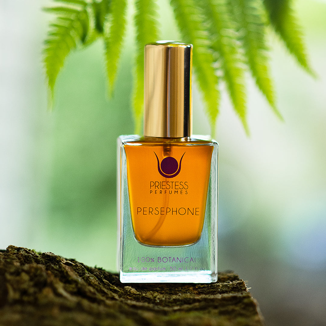 Perfume bottle labeled 'Persephone' by Priestess Perfumes on a natural background