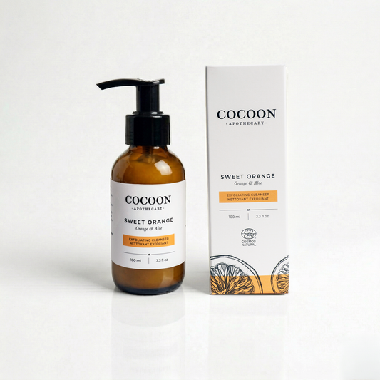 Cocoon Apothecary Sweet Orange skincare product with pump bottle and packaging on a white background